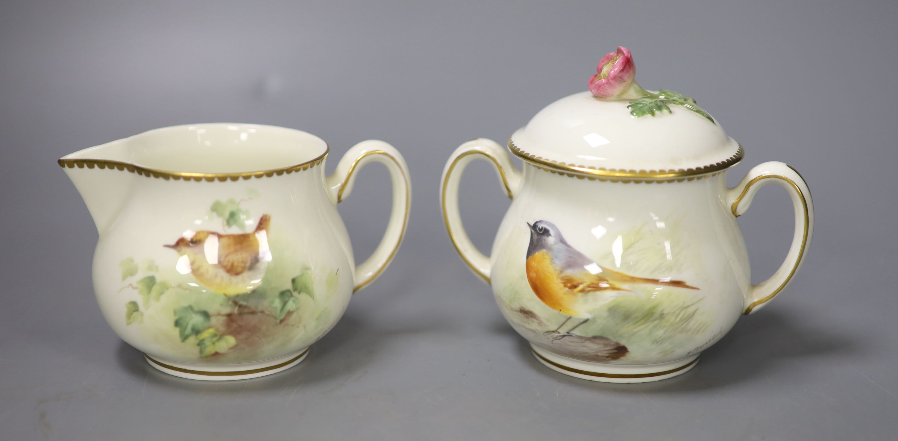 A Royal Worcester sugar bowl painted with a Redstart and cover and a cream jug painted with a Wren by E. Townsend, signed black mark